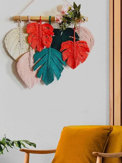 Styled in a cozy corner, this colorful monstera leaf hanging adds a touch of greenery and handmade style. It's a perfect piece for any plant lover.