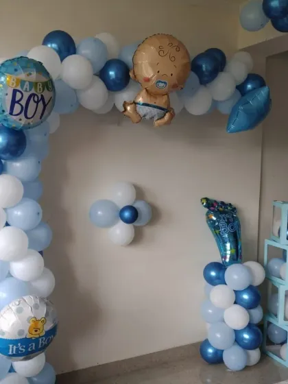 A close-up of the baby boy themed balloon arch and 'BABY' blocks, showing the cute foil balloon details.