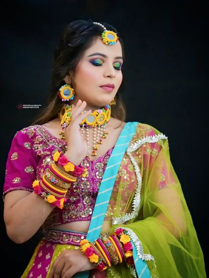 A full view of the Haldi ensemble. The makeup is designed to be bright and cheerful, perfectly matching the celebratory mood of the day.