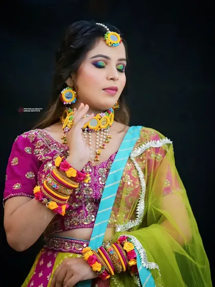 A full view of the Haldi ensemble. The makeup is designed to be bright and cheerful, perfectly matching the celebratory mood of the day.