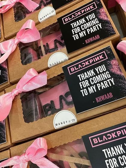 A large order of Blackpink-themed return gifts, all boxed up with personalized "Thank You" tags and pink ribbons.