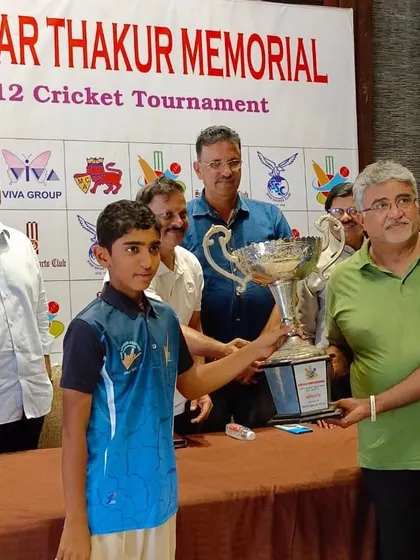 One of our young players proudly receiving the Bhaskar Trophy from former India cricketer Lalchand Rajput.