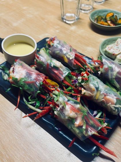 A detailed shot of fresh Vietnamese-style spring rolls from an Asian restaurant. I capture the artistry and freshness of the food, highlighting the quality of the ingredients.