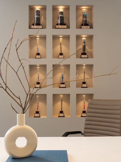 A close-up of the illuminated niches displaying company awards, demonstrating a creative and elegant way to showcase corporate achievements.