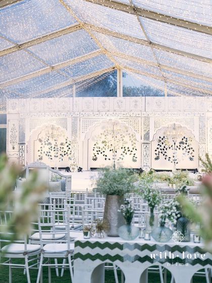 The Thikri stage seen through a frame of greenery, highlighting the contrast between nature and craftsmanship.