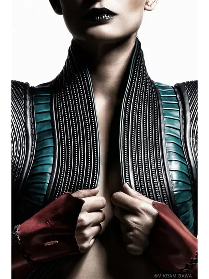 A moment of raw power. This detailed shot captures the incredible texture and structure of the designer's garment, a piece of wearable art.