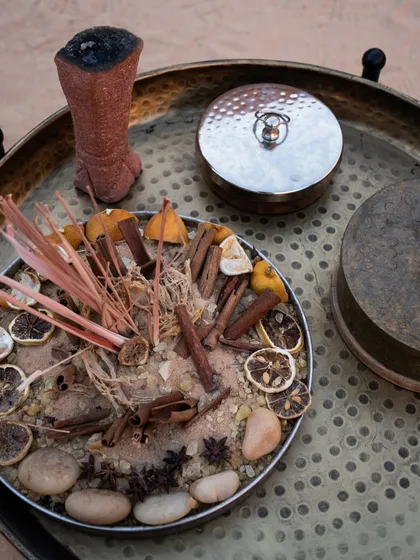 A tray of sacred herbs, spices, and dried citrus used in our desert ritual. We incorporate elements from the earth to honor the five elements and create a multi-sensory healing experience.