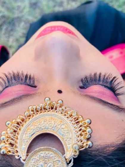 An artistic close-up focusing on the eye makeup. This shot highlights the dramatic false lashes and vibrant pink eyeshadow, showcasing a more creative and bold side of my work.