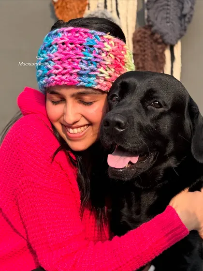 Nothing makes us happier than seeing our creations loved, especially by our furry friends. Here I am wearing one of our cozy, multi-colored winter headbands, perfect for keeping your ears warm in style.
