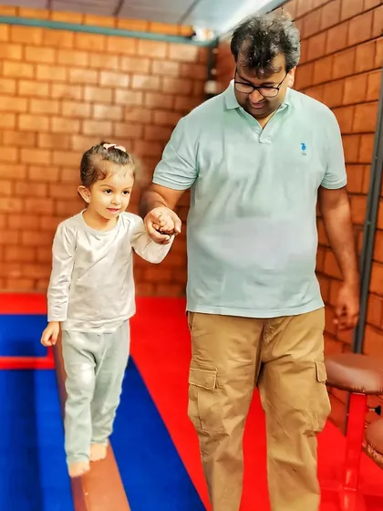 Some of the most precious moments happen when parents join in the fun. A father helps his daughter find her balance, showing how our gym is a place for families to connect and build confidence together.