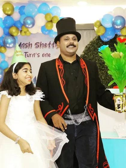 A magical bouquet of flowers appears, and the birthday girl's smile says it all. I use bright, colorful props to keep the show visually exciting for children.