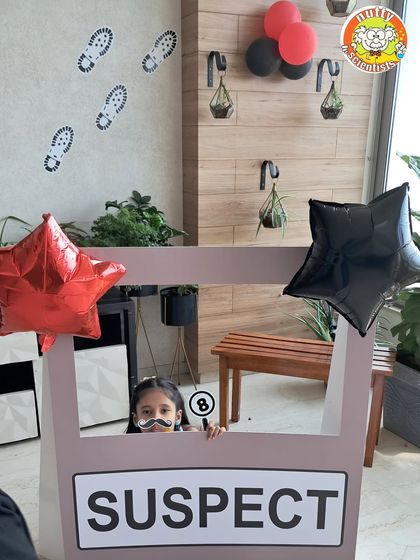 The clues are adding up. With footprints on the wall and a suspect number in hand, this detective is piecing together the puzzle at our interactive CSI birthday event.