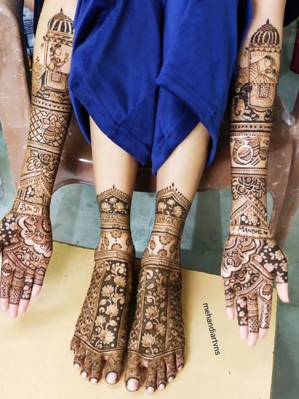 A full view of a bridal mehandi with matching designs on hands and feet. The feet feature beautiful floral patterns that complement the arm designs.