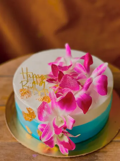 Another angle of the orchid cake, showing how the fresh flowers add a pop of color and elegance.