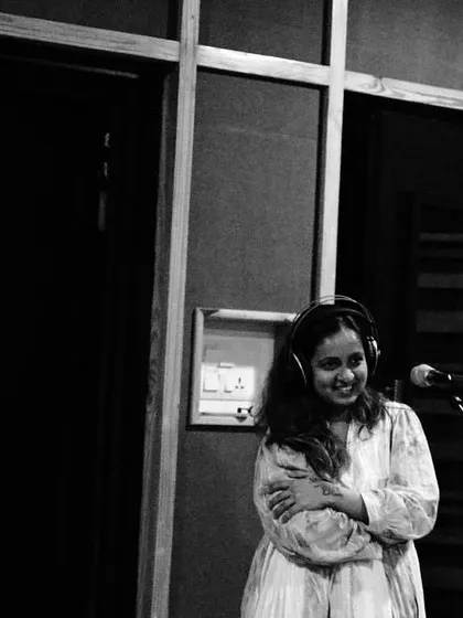 A candid black and white photo of me in the vocal booth. This captures the feeling of being completely lost in the music.