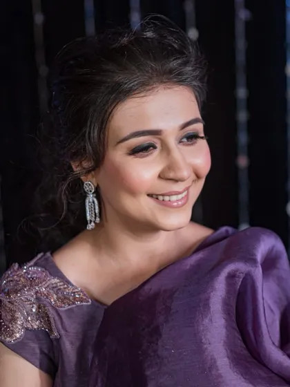 A close-up of the bride's sangeet makeup. The look features flushed cheeks, fluttery lashes, and a hint of shimmer on the eyes for a romantic and elegant feel.