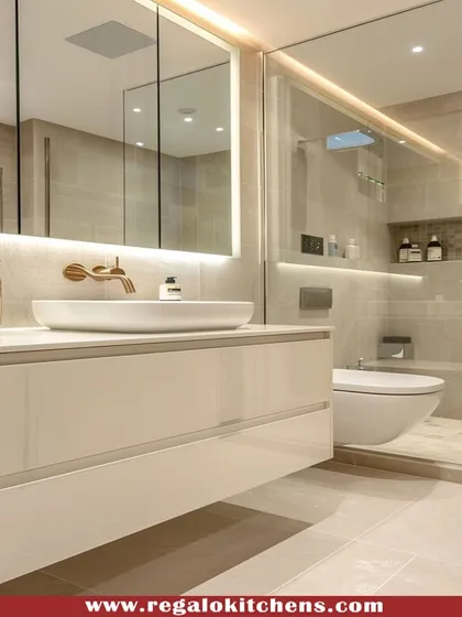 A high-gloss white floating vanity creates a clean and spacious feel in this bathroom. The large, backlit mirror provides excellent lighting for daily routines.