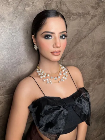 An elegant party look for this stunner. The dark, smokey eyes are the star of the show, balanced with a neutral lip and glowing skin.