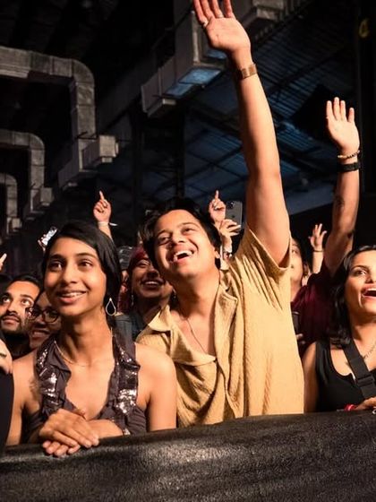 The front row at a Hanumankind concert, with fans fully engaged and singing along. We foster a powerful connection between the artist and the audience through our event management.