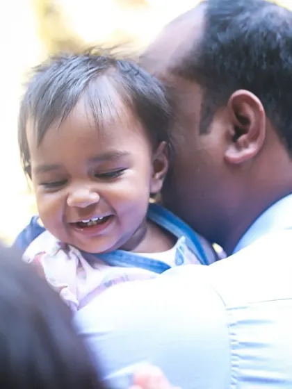 A beautiful candid moment of a father and daughter laughing together. These unposed, natural interactions are what make family photoshoots so special.