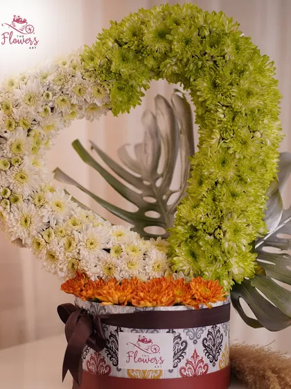 I love creating unique floral sculptures, like this heart-shaped arrangement crafted from green and white chrysanthemums. It's a modern and artistic way to express love or appreciation, presented in a decorative box.