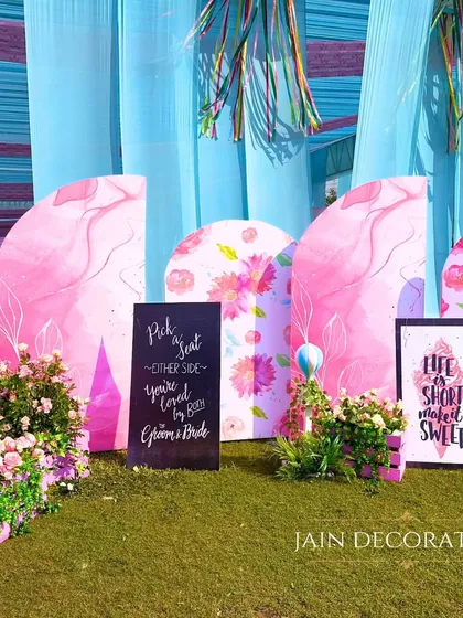 A colorful and artistic backdrop for photos. The hand-painted panels and fun signs create a cheerful and inviting atmosphere for guests.