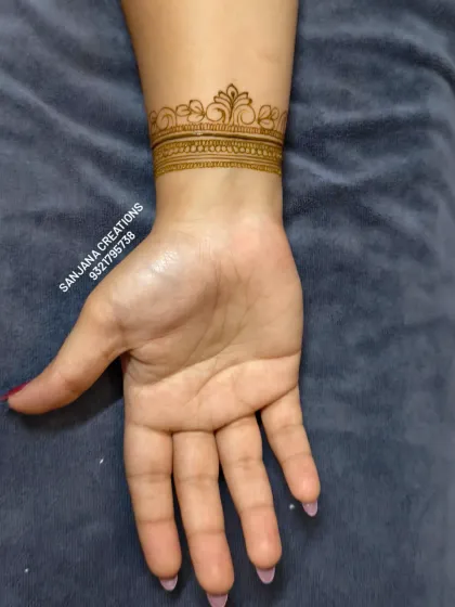 A classic bridal wrist cuff. This design features a traditional crown-like border with intricate line and dot work, a timeless choice for any bride.