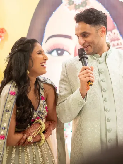 The groom giving a speech or singing for his bride during the Mehendi. A sweet and personal moment.