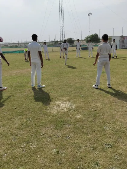 A quick huddle during a fielding drill session. Fitness is not just physical; it is also about communication and strategy, which we integrate into our on-field conditioning to build smarter players.