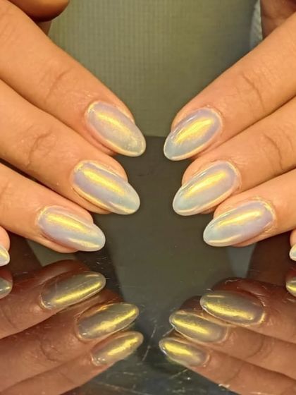 Another shot of the golden cat-eye nails, highlighting their warm, glowing shimmer.