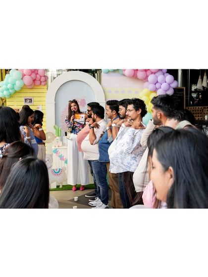 Fun and games are a key part of any baby shower. Here, guests participate in a playful activity, adding to the laughter and joy of the celebration.