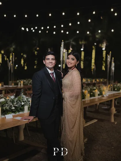A beautiful portrait of the couple at their intimate sit-down dinner. The decor is designed to feel warm, personal, and celebratory.