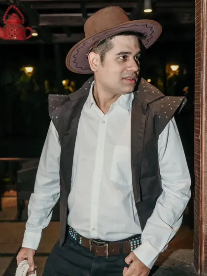 Dressed up in a cowboy costume for a themed event. I am always willing to go the extra mile and dress the part to enhance the event's theme.
