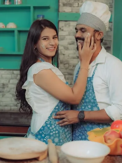 Love is cooking up something beautiful! This couple shares a laugh in a quirky kitchen setting, a perfect example of a themed pre-wedding shoot that reflects shared interests and creates fun, natural interactions.