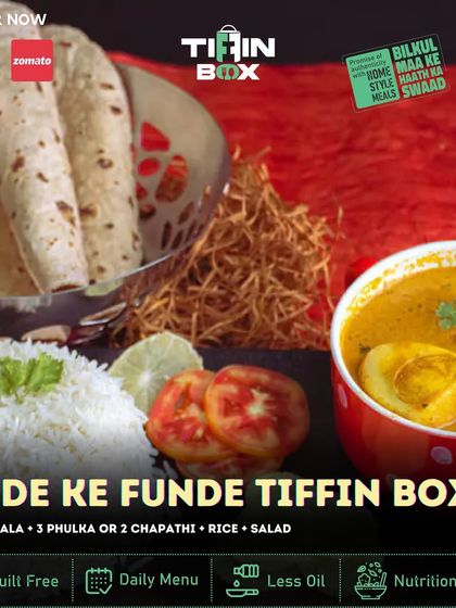 Presenting our 'Ande ke Funde' Tiffin Box for all the egg lovers out there. This meal includes a flavorful egg masala, rice, salad, and your choice of phulka or chapathi. It's a simple, protein packed, and delicious option.