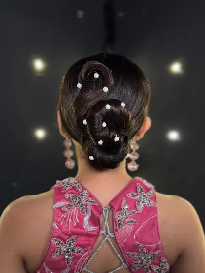 A clear, direct shot of the finished S-wave bun. This view highlights the precise lines and smooth finish that define a professional updo, a key focus in my advanced styling lessons.