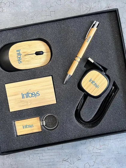 For a more sustainable option, I offer eco-friendly tech kits. This set for Infosys features a wireless mouse, retractable USB cable, card holder, pen, and keychain, all made with bamboo and customized with their logo.