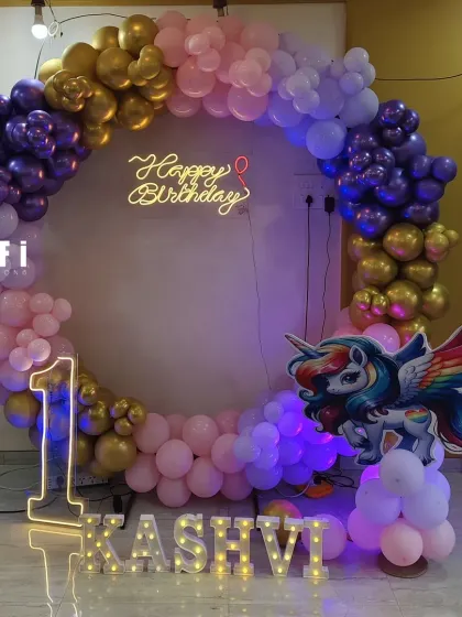 A beautiful unicorn-themed first birthday with a custom name and number display.