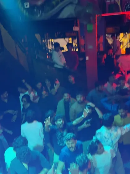 A group of guys enjoying the music and the atmosphere on the dance floor.
