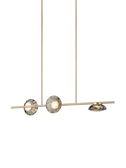 A studio shot of the linear Ceto chandelier with a champagne finish, showcasing its clean lines and balanced composition.