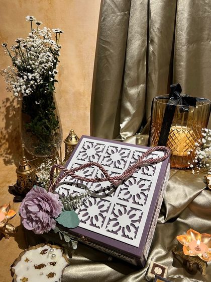 A purple box with a laser-cut jali lid and rope handle. This unique design is perfect for making a statement with your Diwali gifts.