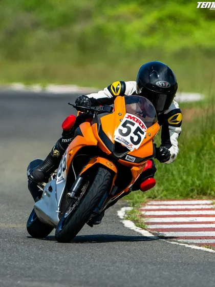 This front-quarter view highlights the rider's head and eye position, looking through the turn towards the exit. This is a key technique I emphasize for smooth and fast cornering on the racetrack.