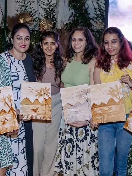 More happy participants from the coffee painting party, showing off their unique creations.