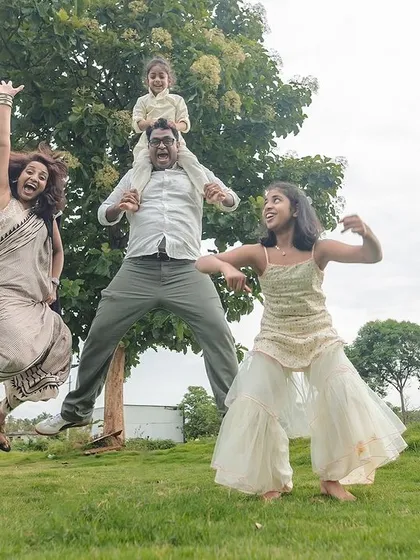 This is what pure, chaotic joy looks like. We believe family photos should be about capturing your unique energy, and outdoor sessions in a place like this Bangalore field give us the space to let everyone's true personality shine.