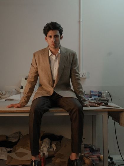 Flawlessly sophisticated. This herringbone single-button linen jacket is paired with matching linen pants and a crisp shirt.