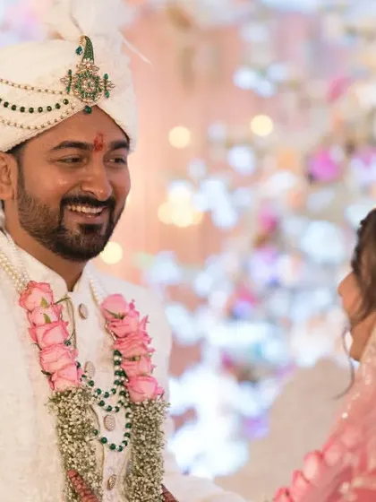 The groom gazes lovingly at his bride during their wedding ceremony, a perfect candid capture.