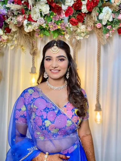 A beautiful smile from the bride-to-be. Simran's makeup is designed to be fun and festive, perfect for a pre-wedding celebration.