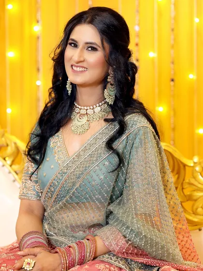 A classic, seated portrait of the bride-to-be, looking radiant and happy during her engagement celebration.