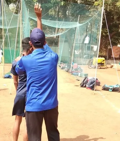 A coach provides instructions to a bowler during a net session. Constant feedback and correction are part of our coaching philosophy.