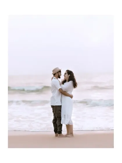 A minimalist and romantic portrait of the couple embracing by the sea.